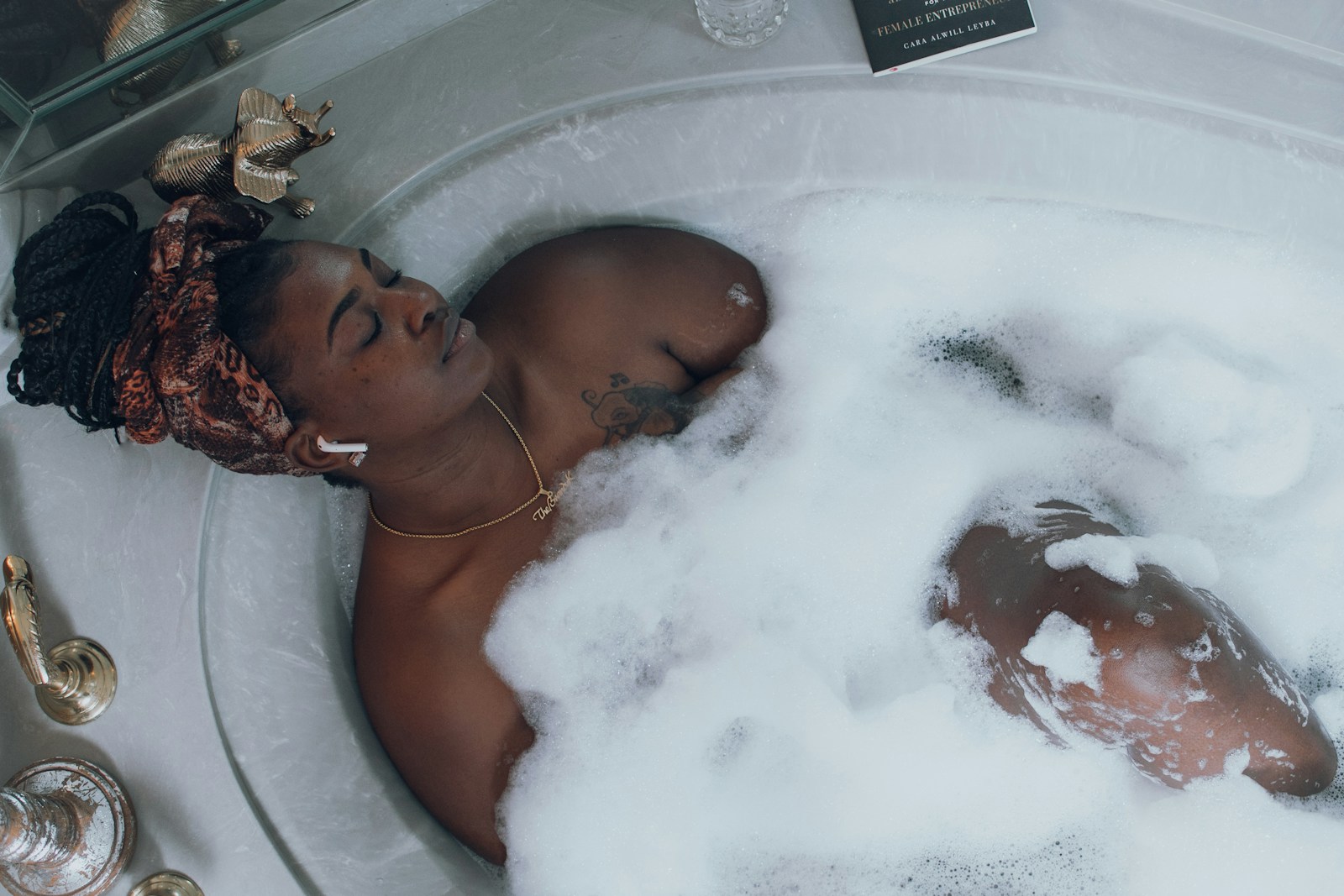 Photo by Brandy Kennedy woman in white bathtub with water